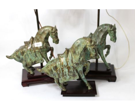 Pair of modern Chinese patinated bronze table lamps in the form of horses, each on a hardwood base with adjustable lamp fitti