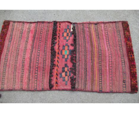 Afghan Kelim and part piled saddle bag, together with a pair of similar Kelim bags and two Chinese straw hats