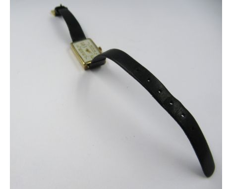 J.W. Benson, ladies rectangular 9ct gold cased wristwatch with black leather strap