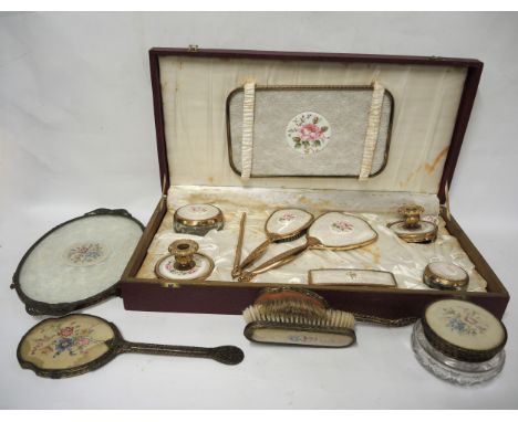 Cased gilt metal dressing table set, together with another similarHas discolouration, one pot is missing its plastic cover an