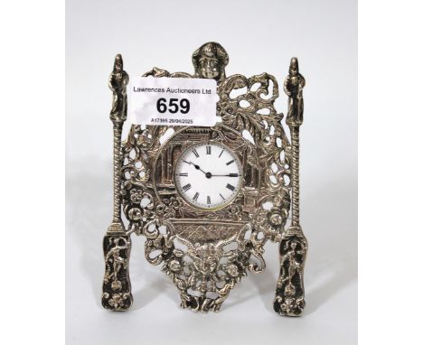 Small cast and pierced silver dressing table clock with enamel dial, Roman numerals and keywind movement12cm high. Does not s