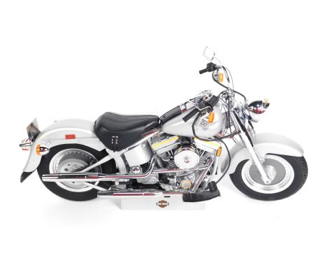 A DeAgostini scale model of a Harley Davidson motorcycle, together with part works, 57cm L.