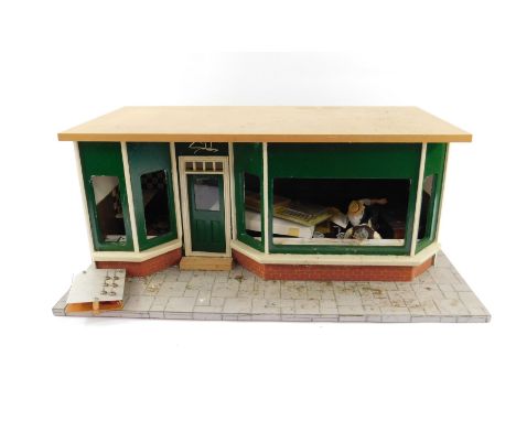 A scale model of a double fronted butcher's shop, with figures and furniture, etc, 29cm H, 69cm W, 35.5cm D, together with tw