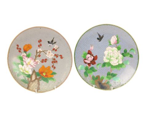 A good pair of Japanese cloisonné enamel small Platters, each decorated with flowers and bird, 25cms (10"). (2) 