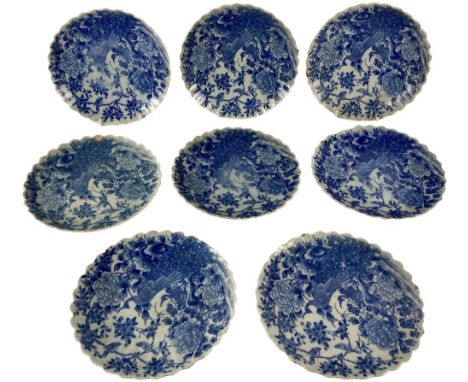 A set of 8 Japanese blue and white porcelain Plates, each with shaped edge and with peacock and other birds, 23cms (9"). (8) 