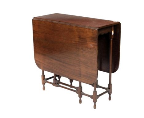 An Edwardian mahogany Yacht Table, the demi lune flaps supported by a gate leg mechanism on spider type legs. (1) 