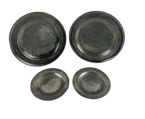 A pair of large antique engraved and crested Pewter Plates, with decorative border and central designed crest with dragons, a
