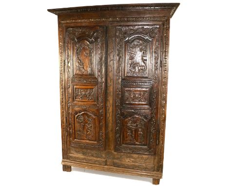 A heavy carved late 18th Century Continental walnut and oak Cupboard,&nbsp;the two triple panel doors each carved in relief w