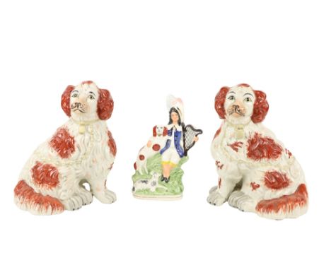 A pair of Staffordshire style porcelain&nbsp;Figures,&nbsp;in red and white, each modelled as a seated King Charles Spaniel, 