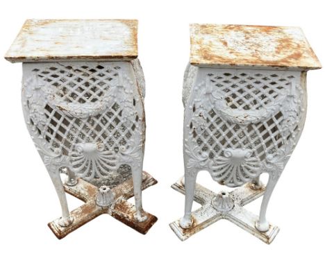 An unusual pair of heavy cast iron Planter Stands, each with a rectangular top, the all around pierced bombe in a trellis sty