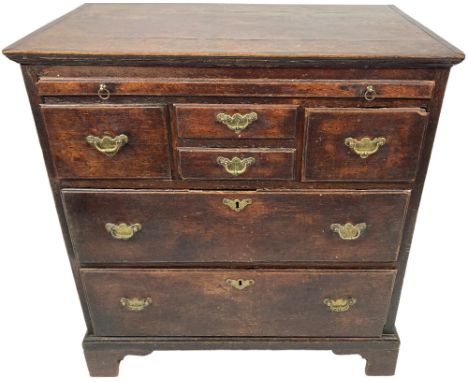 A good 18th Century oak Chest, with an arrangement of four drawers and a brushing slide, the drawers arranged with two small 