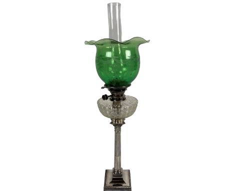 An attractive 19th Century Oil Lamp, with green etched glass shade over a clear glass reservoir, on a plated Corinthian colum