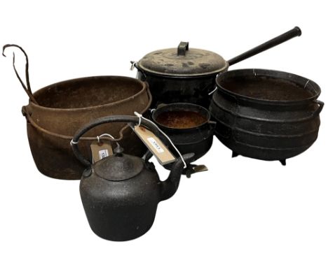 An antique metal Skillet Pot, a small similar ditto, a heavy metal oval Cooking Pot, a small metal Kettle, and an enamel Cook