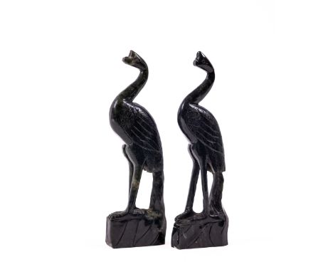 A pair of carved Chinese spinach green jade Figures of Peacocks, 17cms (7"). (2) 