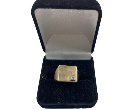 A South African 9ct gold Gentleman's Signet Ring, with a .06ct, 2.5mm diamond inset, approx. 9.8 grms, size R. (1) 