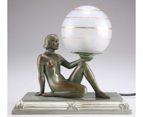 AN ART DECO PATINATED SPELTER FIGURAL TABLE LAMP AN ART DECO PATINATED SPELTER FIGURAL TABLE LAMP, modelled as a reclining fe