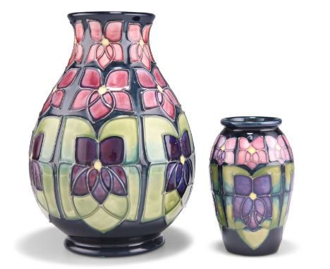 TWO MOORCROFT VIOLET PATTERN TUBE LINED POTTERY VASES TWO MOORCROFT VIOLET PATTERN TUBE LINED POTTERY VASES, designed by Sall