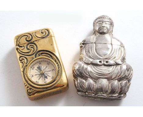 A LATE 19TH CENTURY PLATED VESTA CASE in the form of a meditating Buddha-like figure, and a brass vesta case with chased scro