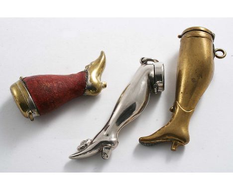 A NICKEL-PLATED LADY'S LEG VESTA CASE suspensory ring, c.1900, another brass example and another smaller brass example with l