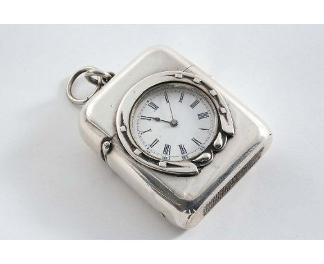 A VICTORIAN PLAIN ROUNDED OBLONG VESTA CASE inset with a time piece within a horseshoe surround, suspensory ring, by Thomas J
