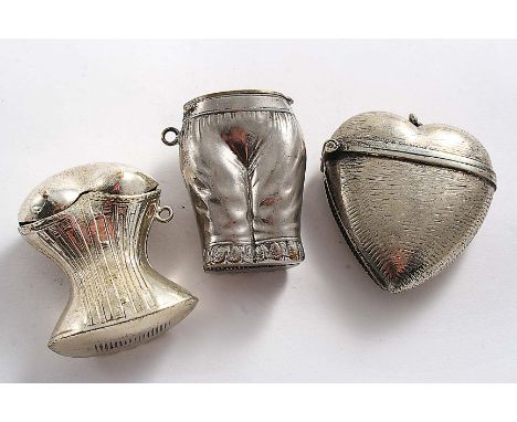 A LATE 19TH CENTURY PLATED VESTA CASE in the form of a corsetted waist & bust, a plated heart-shaped vesta case, suspensory r