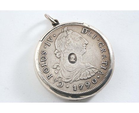 A LATE VICTORIAN CIRCULAR VESTA CASE made from a countermarked eight Reales coin, suspensory ring, unmarked;  1.75"  (4.5 cms