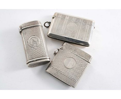 A LATE VICTORIAN ENGINE-TURNED VESTA CASE of oval tubular section, crested, maker's mark "D&M", Birmingham 1873 and two other