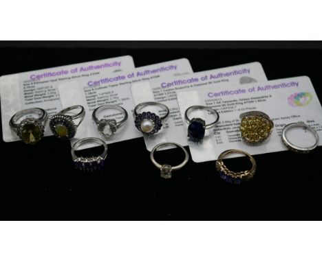 A collection of ten gemset rings, four with certificates. To include a 9ct yellow gold cocktail ring set with scapolite and d