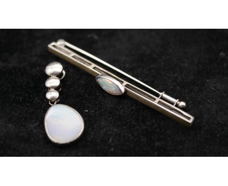 A white metal (tests as 14ct) marquise opal cabochon bar brooch with secure hinged pin to the back with sliding safety catch 