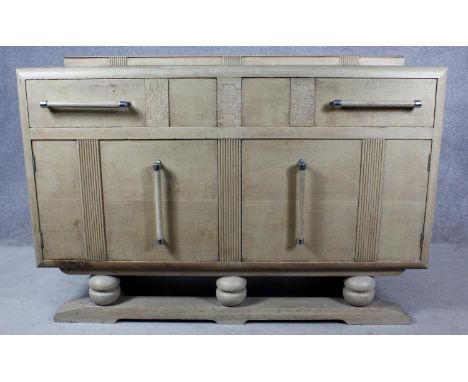 A mid century Art Deco style light oak sideboard. H.95 W.138 D.54cm 