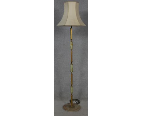 A mid century vintage onyx and brass standard lamp on circular platform base.173cm 