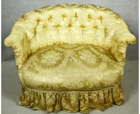 A 19th century two seater tub sofa in deep buttoned damask upholstery on turned tapering supports. H.76 W.105 D.90cm 