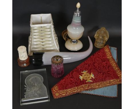 A collection of decorative items. Including a blown glass horn, a gold thread embroidered altar piece, a vintage marbled glas