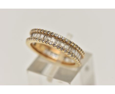 A YELLOW METAL DIAMOND BAND RING, set with a central row of baguette cut diamonds, between two rows of small round brilliant 