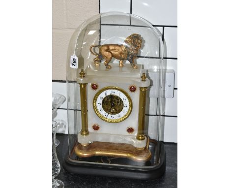 A LATE 19TH CENTURY FRENCH ALABASTER MANTEL CLOCK UNDER A GLASS DOME, the rectangular clock with gilt spelter lion surmount, 