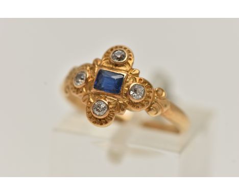 A YELLOW METAL SAPPHIRE AND DIAMOND RING, centring on a rectangular cut blue sapphire, collet set, within a surround of four 