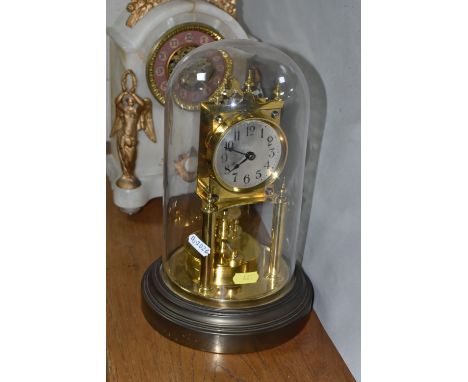 TWO CLOCKS, comprising a white marble cased mantel clock with brocot escapement, two gilt metal winged figures, foliate decor