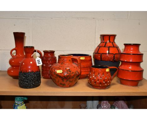 EIGHT WEST GERMAN RED GLAZED POTTERY VASES, EWERS, ETC, including a twin handled vase, height 25cm, a mug with impressed text