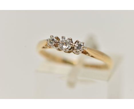 A THREE STONE DIAMOND RING, three old cut diamonds, prong set in white metal, leading on to a yellow metal high polished shan