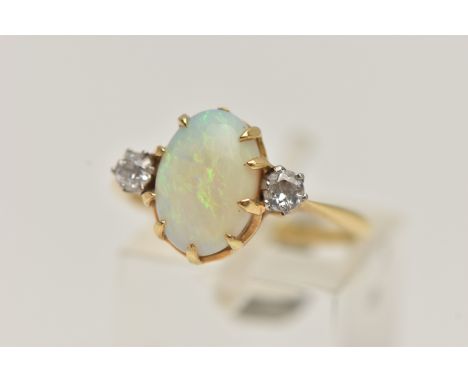 A YELLOW METAL OPAL AND DIAMOND RING, centring on an oval cut opal cabochon, in a nine claw setting, opal measuring approxima