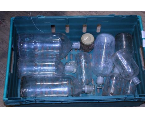 A tray full of vintage glass bottles 