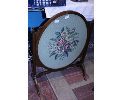 A Edwardian oak firescreen with embroidered panel. Shipping unavailable 
