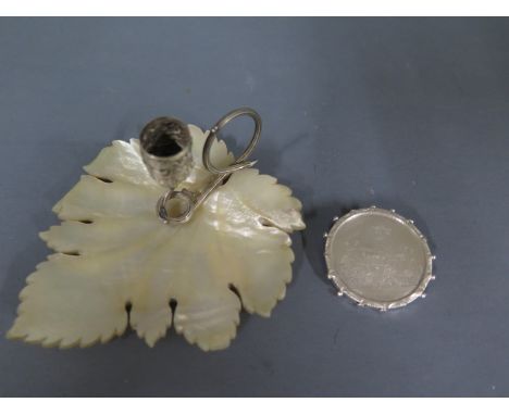 A white metal brooch of circular form with St Albans Abbey etched to front, dated 1882 and a mother of pearl and white metal 