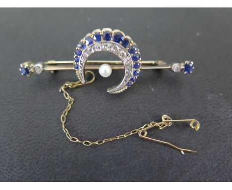 An early 20th century yellow gold diamond and sapphire crescent brooch with a central pearl, the crescent set with 15 sapphir