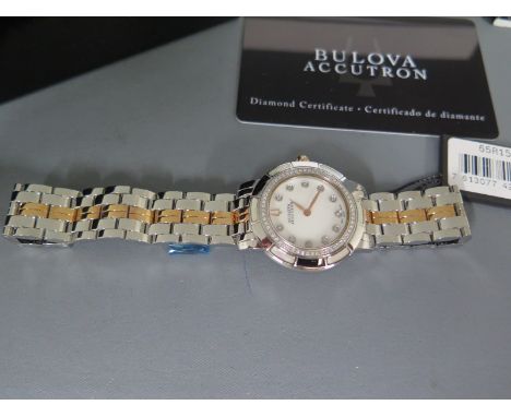 A ladies Bi colour Bulova Accutron diamond dot bracelet stainless steel watch with mother of pearl dial with eleven diamond d