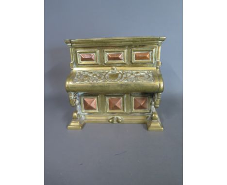A brass inkwell formed as a piano, 5 inches wide, marked to base Rd No 153846 - surface wear from use, lacking one inkwell