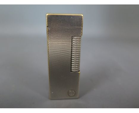 A silver plated Dunhill lighter with engine turned finish Condition report:   Plate wearing 