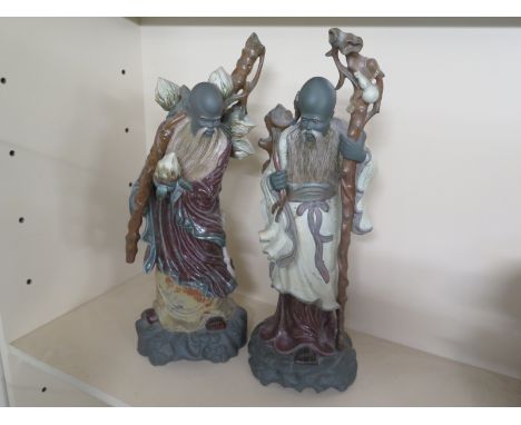 A pair of Lladro Oriental figures of Daiteys both 55cm in height - one of figures has breakage's to object in right hand