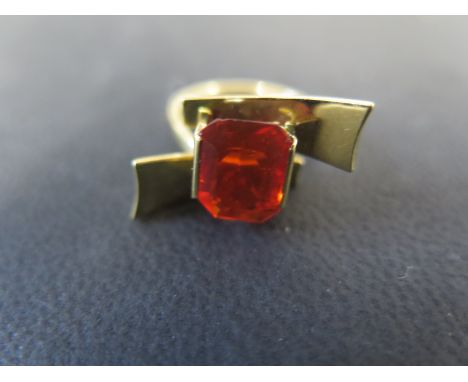 An 18ct yellow gold solitaire fire opal ring the emerald cut stone of good quality being clear and transparent - approx 10mm 