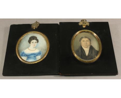 TWO 19TH CENTURY PORTRAIT MINIATURES each of oval form, watercolours on card, depicting a lady and gentleman, in gilt slips a